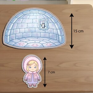Size guide for DIY Eskimo igloo paper dollhouse: 15 cm igloo and 7 cm chibi girl doll. Printable winter-themed craft set dimensions for kids' arctic roleplay, busy books, and Montessori activities.