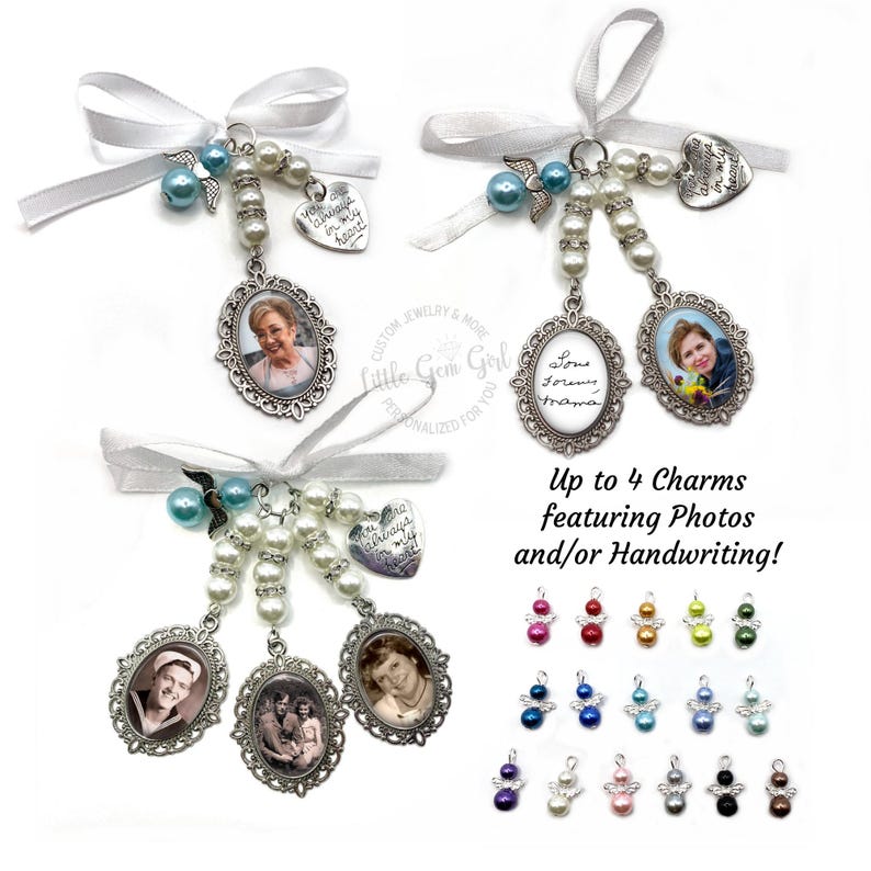 May include: Two sets of memorial charms featuring photos and handwritten messages. Each set includes a white satin ribbon, pearl beads, and a charm with the text "You will always be in my heart". The charms are silver-toned and oval-shaped with a decorative border. The charms can be customised with up to four photos or handwritten messages. The image also shows a variety of angel charms in different colours.