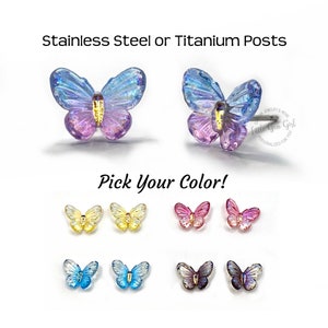 May include: A pair of butterfly earrings with iridescent wings. The earrings are available in a variety of colors, including yellow, pink, blue, and purple. The earrings are made with stainless steel or titanium posts. "Pick Your Color!" is written in the image.