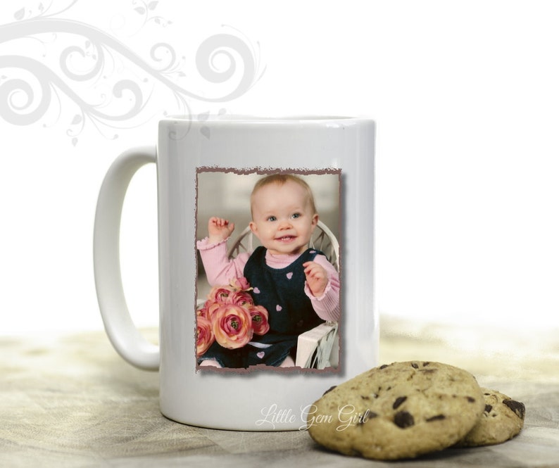 May include: White ceramic mug with a photo of a baby girl in a pink and black dress holding a bouquet of pink flowers. The mug has the text "Little Gem Girl" printed on the bottom.