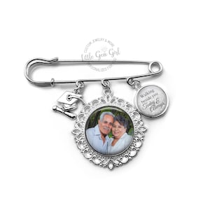 May include: Silver graduation pin with a photo charm, a graduation cap charm, and a charm that says "Walking beside you Today & Always".