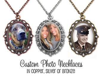May include: Three custom photo necklaces with oval-shaped frames. The frames are ornate and have a filigree design. The necklaces are available in copper, silver, or bronze. The text "Little Gem Girl" is visible on two of the necklaces.