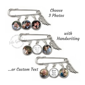 May include: A silver safety pin with three round photo charms and a silver angel wing charm. The photo charms feature images of people. The text "Choose 3 Photos" and "with Handwriting" is visible above the pin. The text "...or Custom Text" is visible below the pin. The text "Your Text Here" is visible on one of the photo charms.