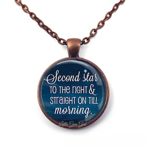 May include: A copper chain necklace with a round pendant featuring a blue starry night sky background and the text "Second star to the right & straight on till morning." The pendant also includes the text "Little Gem Girl".