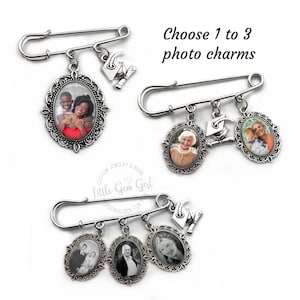 May include: Silver safety pin with three oval photo charms and a graduation cap charm. The photo charms have ornate silver frames. The text "Choose 1 to 3 photo charms" is above the pin.