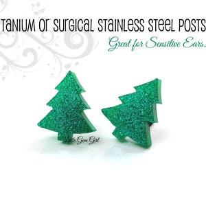 May include: A pair of green glitter Christmas tree earrings with titanium or surgical stainless steel posts. "Great for Sensitive Ears!" is written on the image.
