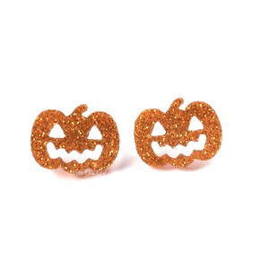 May include: A pair of orange glitter pumpkin earrings. The pumpkins are cut out and have a jack-o'-lantern face.