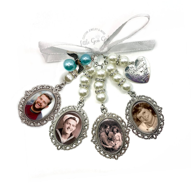 May include: A silver charm bracelet featuring a heart charm inscribed with the words "You are always in my heart!" and four oval photo charms. The photo charms display black and white photographs of individuals. The bracelet is adorned with white pearls and blue beads.