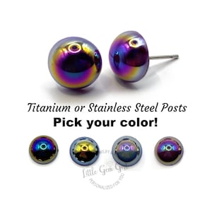 May include: A pair of iridescent earrings with titanium or stainless steel posts. The earrings are available in a variety of colors, including black, gold, and purple.  "Titanium or Stainless Steel Posts Pick your color!" is written below the earrings.