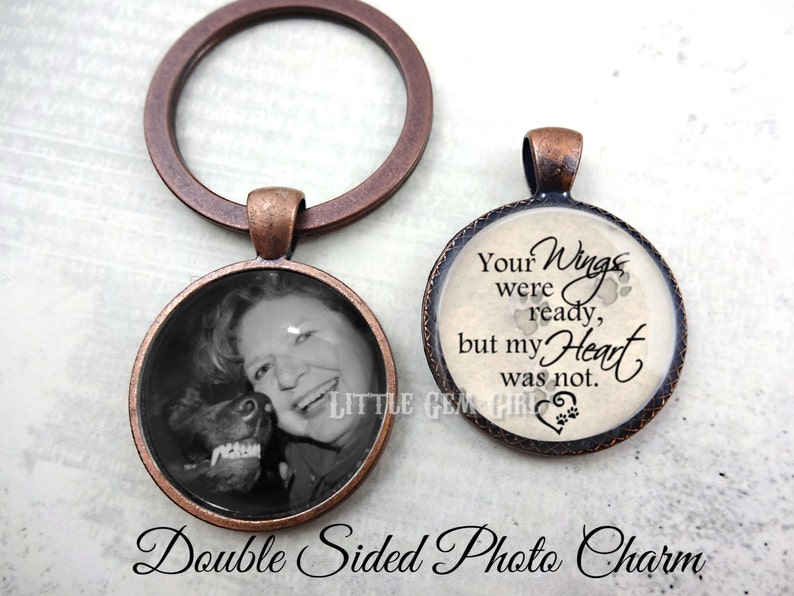 May include: Double-sided photo charm with a copper-toned metal frame. One side features a black and white photo of a woman and a dog. The other side has a white background with the text "Your Wings were ready, but my Heart was not." and paw prints.