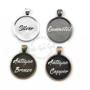 May include: Four round metal pendant blanks with different finishes: silver, gunmetal, antique bronze, and antique copper. Each blank has a decorative pattern and the finish name is printed in white.