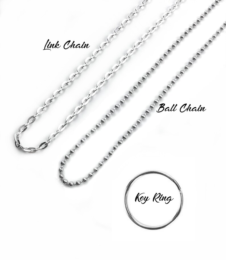 May include: Three silver chains, a link chain, a ball chain, and a key ring. The chains are laid out on a white background.