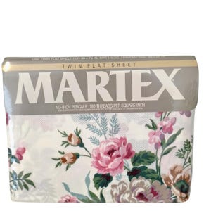 May include: A folded twin flat sheet with a floral design. The sheet displays pink and brown roses with green leaves on a white backdrop. The packaging reads "MARTEX" and "NO-IRON PERCALE 180 THREADS PER SQUARE INCH". The sheet is for a 99 x 190 cm mattress.