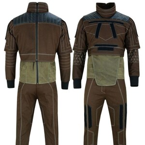 May include: Brown jumpsuit with black accents, featuring a high collar and a zip-up front. The suit has a green panel at the waist and black cuffs. White stitching details the design. The outfit is displayed from the front and back.