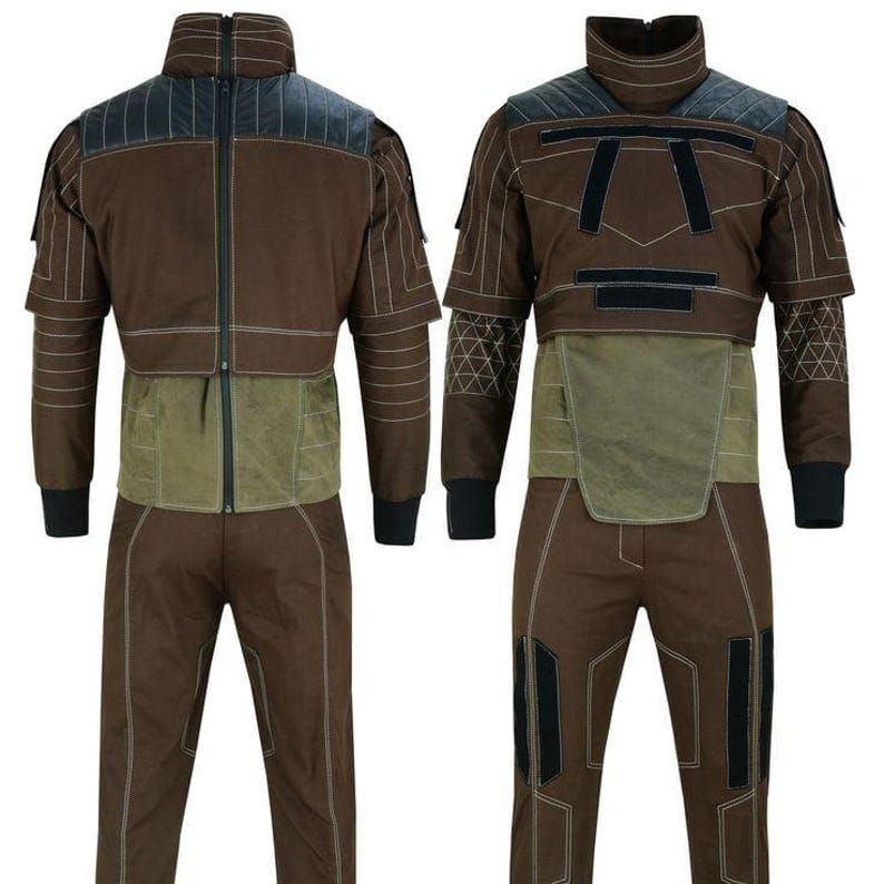 May include: Brown jumpsuit with black accents, featuring a high collar and a zip-up front. The suit has a green panel at the waist and black cuffs. White stitching details the design. The outfit is displayed from the front and back.
