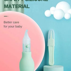 May include: A baby care kit featuring a green nasal aspirator and a small tool with a protective cap. The image includes text that reads "SAFETY SILICONE MATERIAL" and "Better care for your baby". The background is a mix of pink and blue.