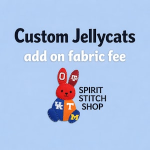 May include: A red, orange, and blue bunny-shaped plush toy with college logos. The text "Custom Jellycats" and "add on fabric fee" are above the bunny. The Spirit Stitch Shop logo is on the right side of the image.