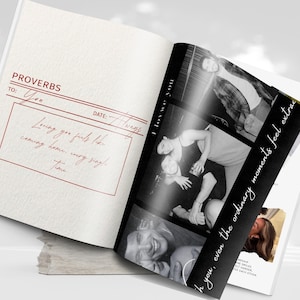 May include: An open book with a red-lined page featuring the word "PROVERBS" and handwritten text. The right page displays black and white photos with the text "I love you" and "even the ordinary moments feel extra."