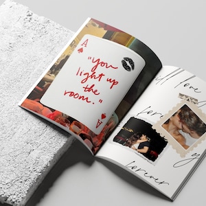 May include: Open magazine with a white page featuring a playing card with the text "you light up the room." and a kiss mark. The opposite page has photos and the words "I will love you forever."