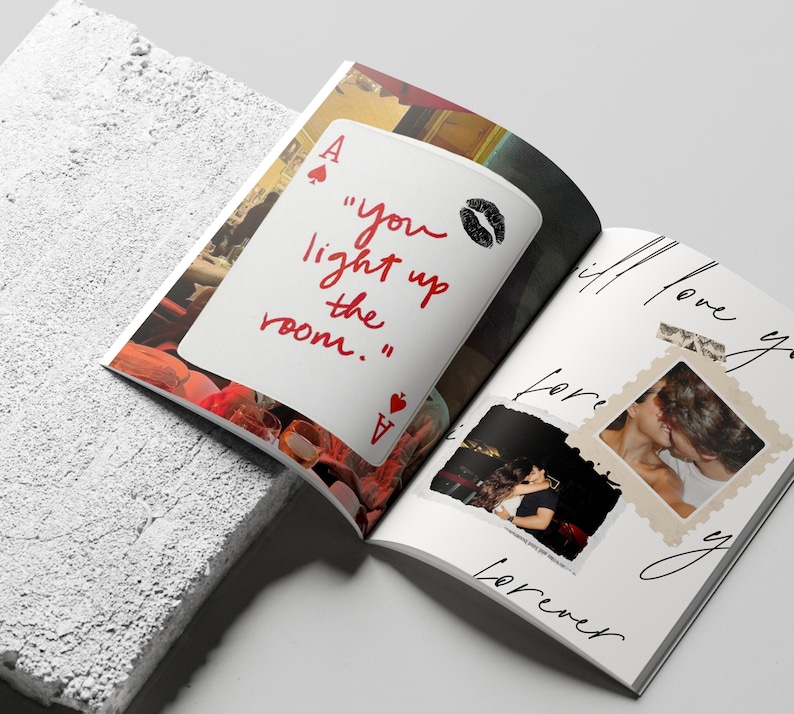 May include: Open magazine with a white page featuring a playing card with the text "you light up the room." and a kiss mark. The opposite page has photos and the words "I will love you forever."
