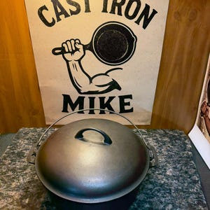 May include: A cast iron Dutch oven with a lid and a handle. The background features a sign with the words "CAST IRON MIKE" and an illustration of a muscular arm holding a skillet.