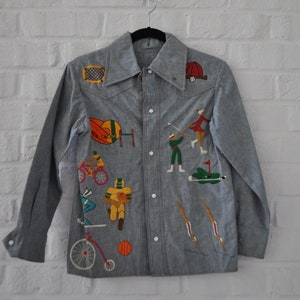 Vintage jeans jacket with lots of hand stitched sports emblems
