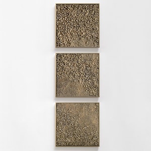 May include: Three square wall art pieces with a textured, bronze-coloured surface. Each piece is framed in a thin, gold-coloured border. The texture appears to be made up of small, rounded shapes, creating a unique, tactile appearance. The art is displayed against a white background.