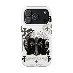 Op de afbeelding: Witte telefoonhoes met een zwart-wit Chrome Hearts ontwerp. Het ontwerp bevat een kruis, bloemaccenten en de merknaam. De hoes heeft een glanzende afwerking en is ontworpen voor een smartphone.