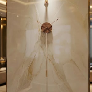 May include: A contemporary wall clock featuring a wooden clock face and gold-toned hands and pendulum. The clock is mounted on a marble-effect wall. The design is minimalist and elegant, suitable for home decor.