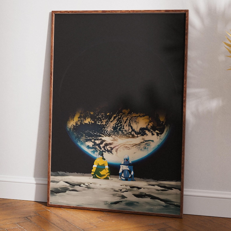 May include: A framed rectangular wall art print featuring two figures sitting on a rocky lunar surface, looking up at a glowing, partially illuminated Earth against a deep black space background. The figures wear yellow and blue jackets.