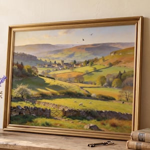 May include: A framed landscape painting in a gold frame shows a rural scene with rolling hills, a village, and sheep grazing. A vase of blue and white flowers sits on a wooden surface near the painting.