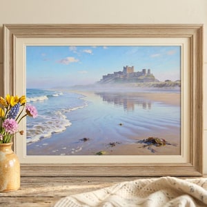 May include: A framed print of a coastal landscape featuring a castle on a hill. The beach has gentle waves, and the sky is blue with clouds. A vase of flowers sits in front.