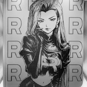 May include: A monochrome binder with a manga-style illustration of a woman in a black outfit with the letter "R" on the chest. The background has a repeating pattern of the letter "R". The binder is likely for trading cards or other collectibles.
