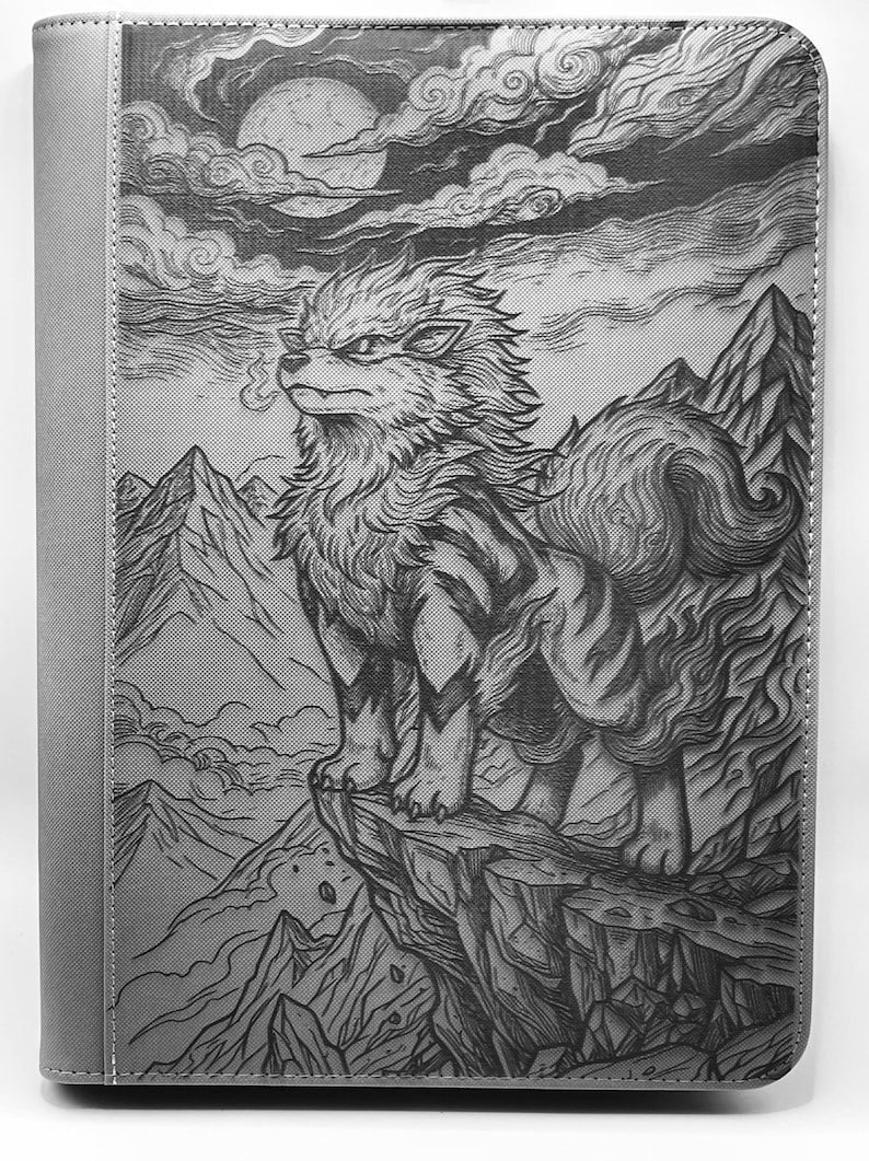 May include: A gray binder featuring a detailed illustration of a wolf-like creature perched on a cliff, with a mountain range and a full moon in the background. The artwork is in a detailed, grayscale style, with a solid gray spine.
