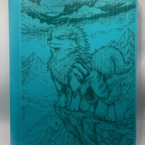 May include: Teal card binder featuring a detailed illustration of a wolf-like creature on a cliff, with mountains and a moon in the background. The design is in a darker teal, creating a textured, artistic look. The spine is a solid teal.