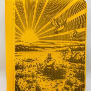 May include: A yellow zippered binder with a detailed illustration. The artwork depicts a sunrise with radiating beams, birds in flight, and a landscape scene. The binder's spine and edges are a solid yellow.