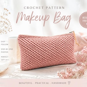 May include: A pink crocheted makeup bag with a zip closure. The text "CROCHET PATTERN Makeup Bag" is displayed at the top. Additional text includes "EASY TO FOLLOW", "STEP-BY-STEP PHOTOS", and "PERFECT GIFT IDEA". The bag is beginner friendly and handmade.