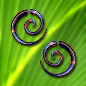 May include: A pair of spiral-shaped earrings made of wood with a blue, black, and red swirl pattern.