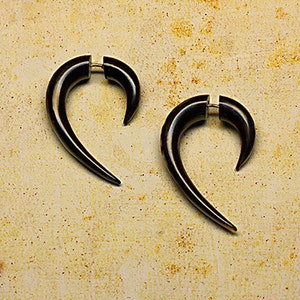 May include: A pair of black curved wooden earrings. The earrings are shaped like a crescent moon and have a silver post.