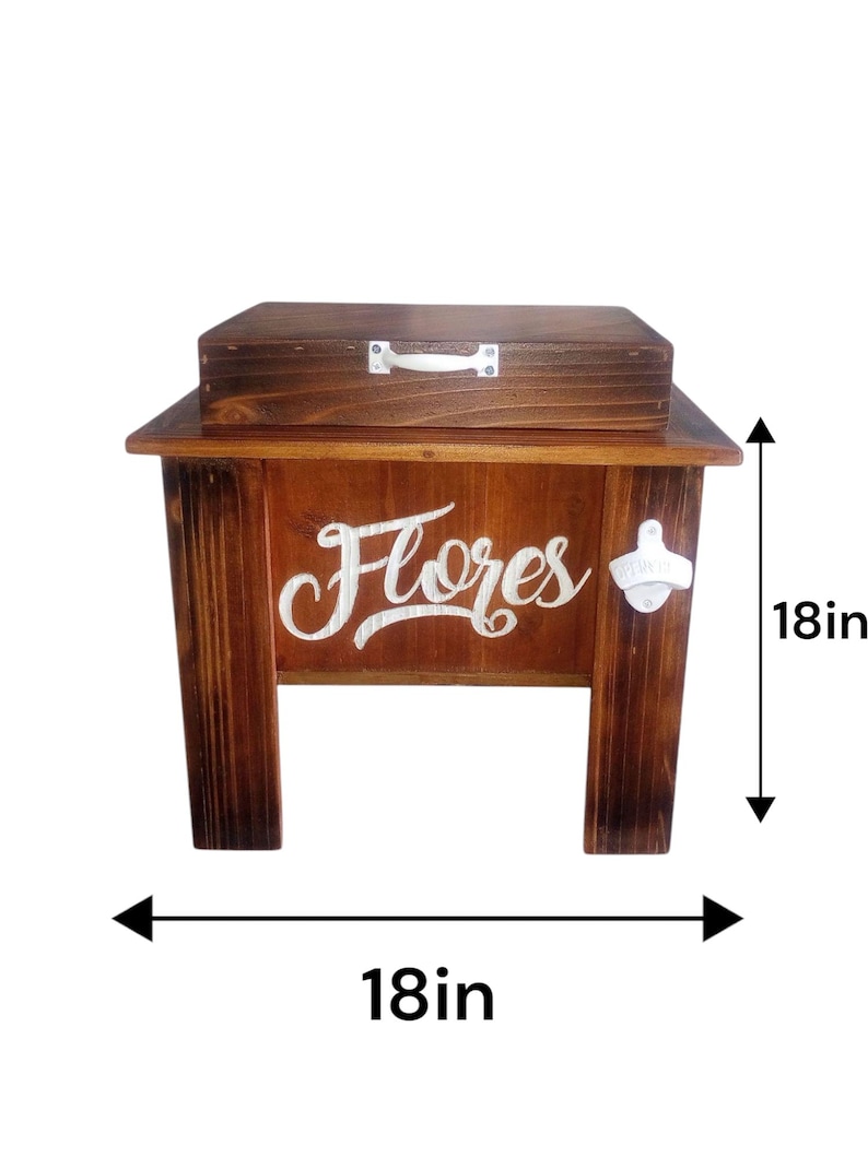 May include: A wooden cooler with a dark stain, featuring the word "Flores" in white script. The cooler has a lid and a bottle opener. It measures 18 inches in height and 18 inches in width.