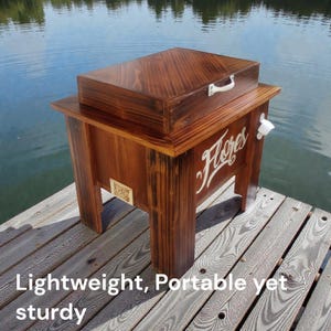 May include: A wooden cooler with a dark brown finish, featuring a matching lid and a white handle. The cooler has the word "Flores" in white script on the front and a bottle opener. The text "Lightweight, Portable yet sturdy" is at the bottom.