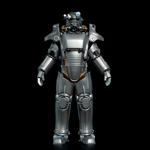 May include: A full-body, silver-colored power armor suit with a helmet, chest plate, and leg armor. The suit has a metallic finish with visible joints and details, set against a black background. The armor appears to be a replica or collectible item.