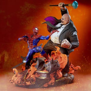 May include: A detailed statue depicting a battle scene between Spider-Man and Kingpin. Spider-Man is in a dynamic pose, while Kingpin wields a weapon. The base features fiery elements, with a vibrant orange and red colour scheme.