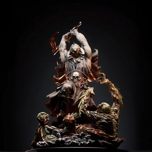 May include: A detailed sculpture of a warrior figure in a dynamic pose, wielding a weapon above his head. The figure is clad in armor with a skull emblem, and is surrounded by smaller, grotesque figures. The color palette is primarily muted browns and grays.