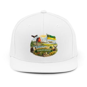 May include: White baseball cap featuring a colorful graphic of the Saskatchewan provincial emblem. The emblem includes a flag, a red barn, wildlife, and the word "Saskatchewan".