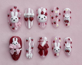 Kawaii bunny strawberry press on nails with 3D bows, pink glossy base, cute rabbit designs, sweet girly aesthetic, handmade kawaii nail art
