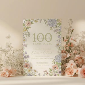 May include: A floral-themed invitation card with the text "100 Years Loved." The card features a cream background with a floral border of pink, purple, and yellow flowers. The text reads "Eleanor Clark" and the date of the event.