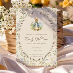 May include: Baby shower invitation featuring a watercolor illustration of a rabbit wearing a blue jacket. The invitation has a floral design with the text "PLEASE JOIN US FOR A BABY SHOWER HONORING Emily Williams" and event details.