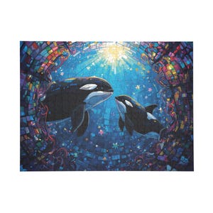 May include: A jigsaw puzzle featuring two orcas swimming in a blue ocean with a mosaic background. The orcas are black and white, with one larger than the other. The puzzle has a colorful, artistic design.