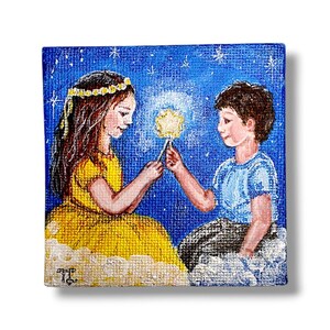 May include: A square painting depicts two children sharing a glowing star against a starry blue sky. The girl wears a yellow dress and flower crown, while the boy is in a blue shirt. They appear to be sitting on clouds.